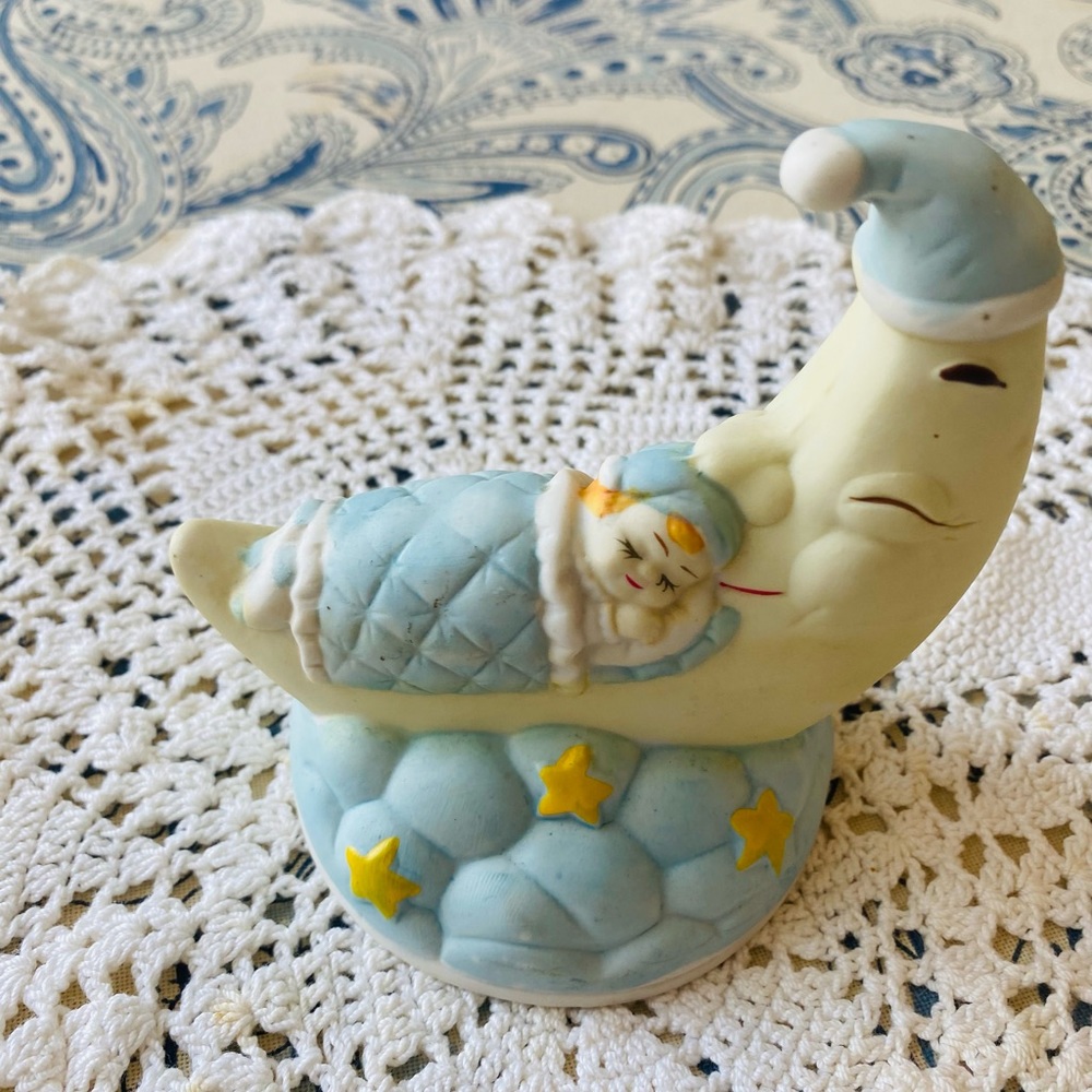Porcelain baby sleeping on the quarter moon